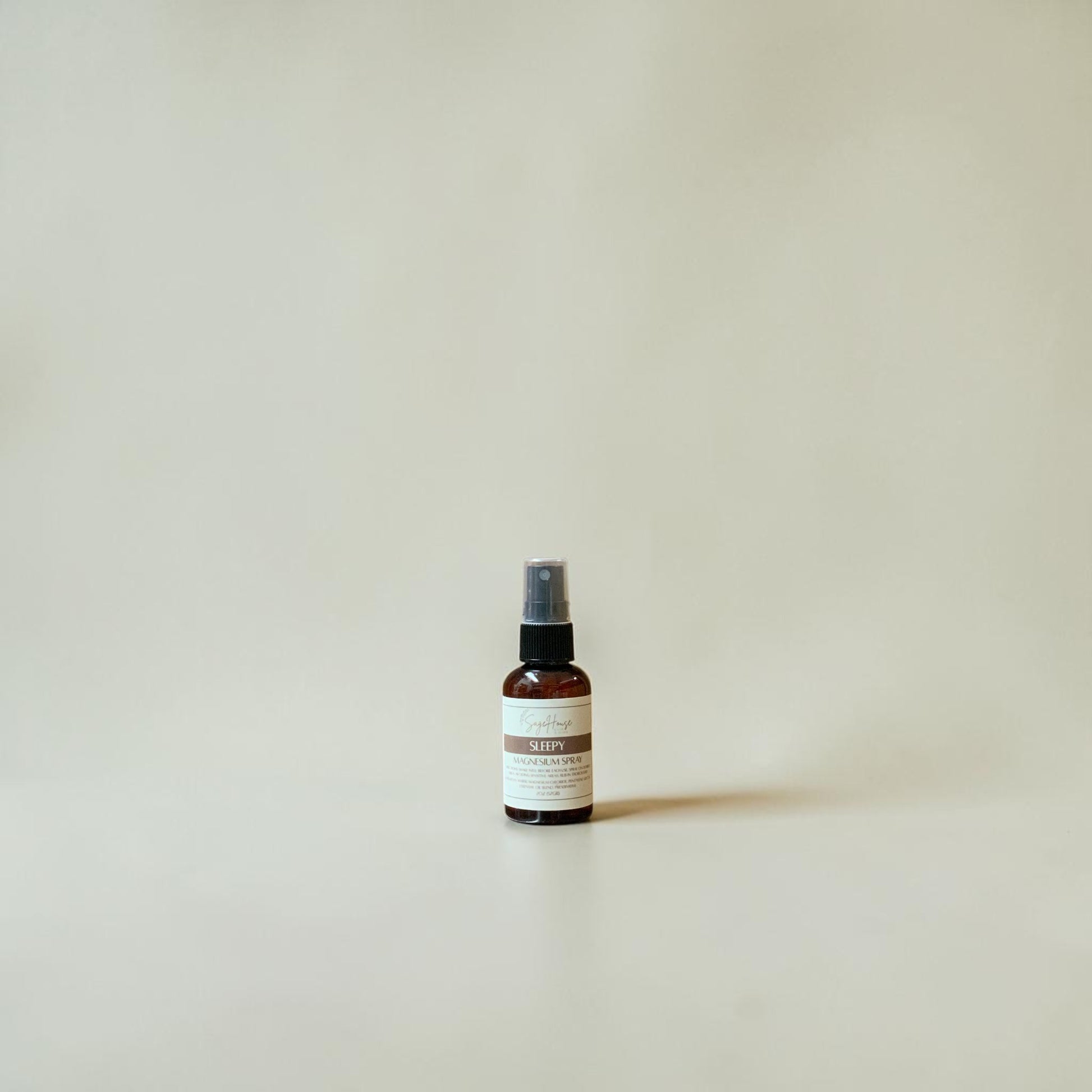 Small spray bottle with a label on a plain background