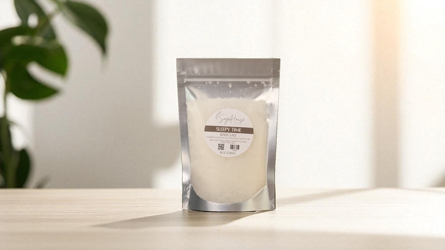 Silver packaging with a clear window of white salt labeled "sleepy time" on a wood surface.