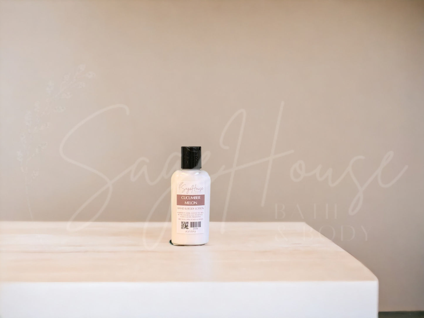 A small bottle of lotion with black cap on a wooden surface with a neutral background