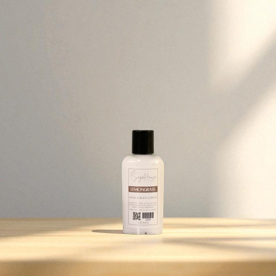 White bottle of lotion with black cap top on a light wooden surface with a blurred white background