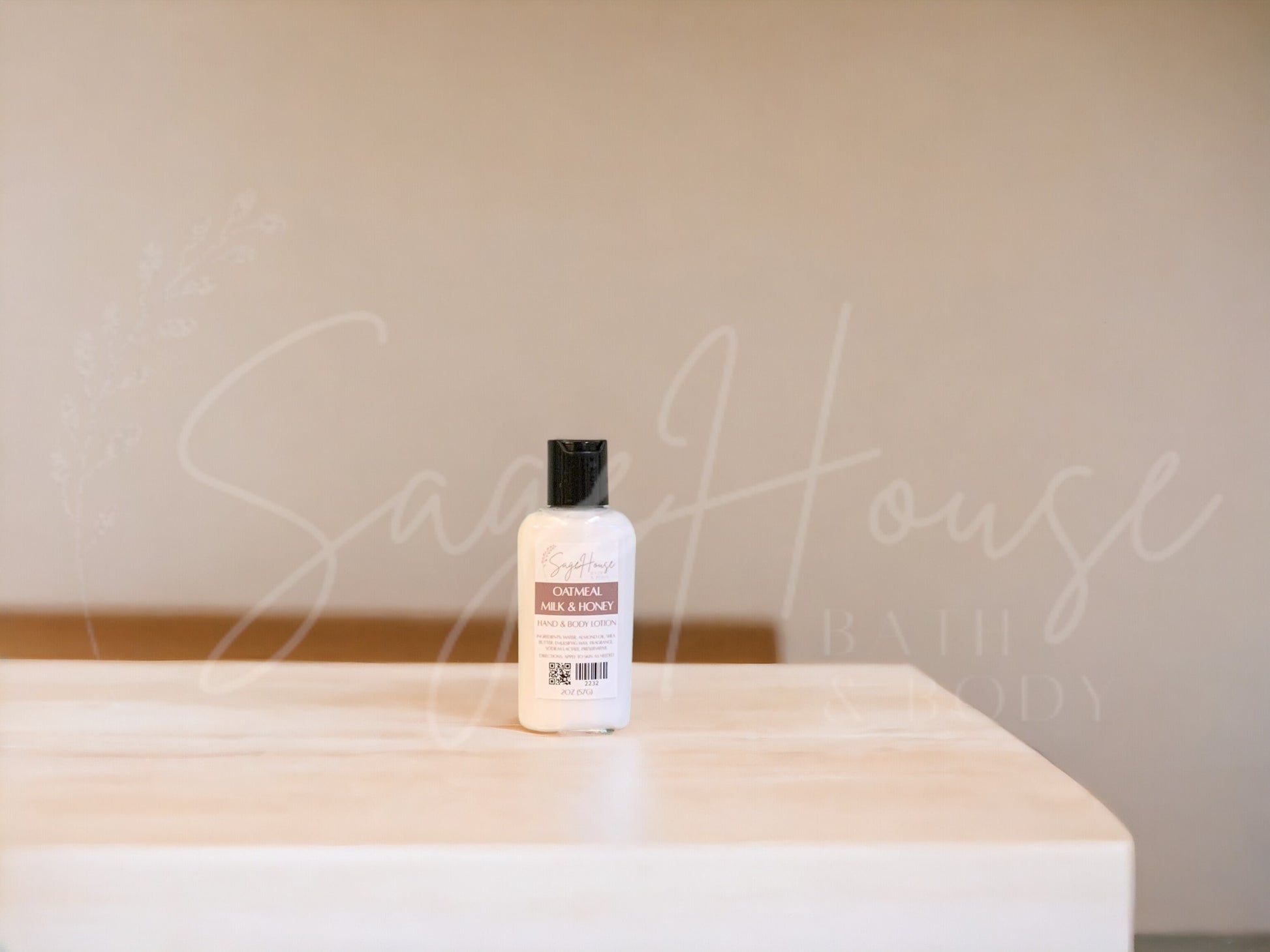 Small bottle of lotion with black cap on a wooden surface with a neutral background
