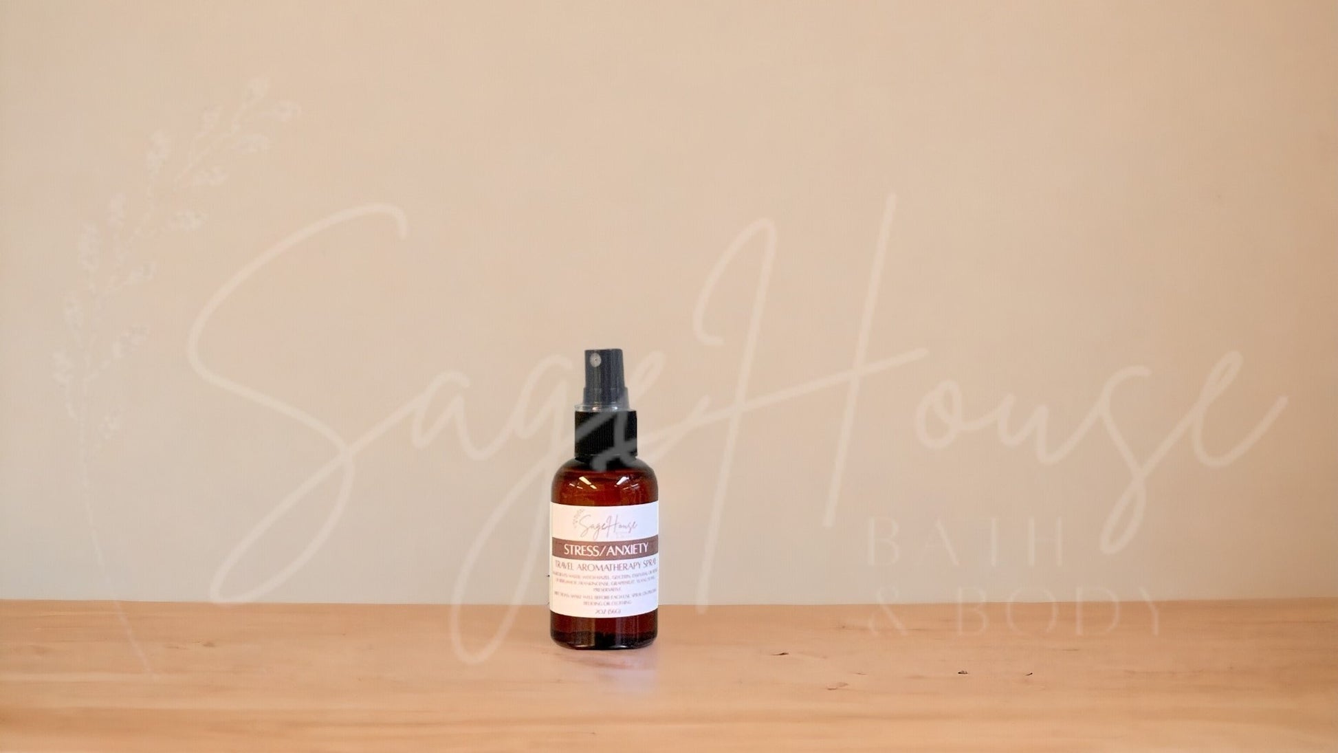 Amber colored spritz bottle with anxiety and stress label, on wood surface