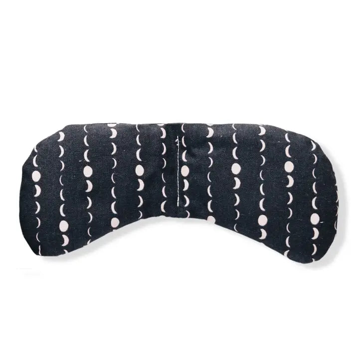 An eye mask therapy pack with a star and moon design on a dark blue fabric. displayed on a white background.