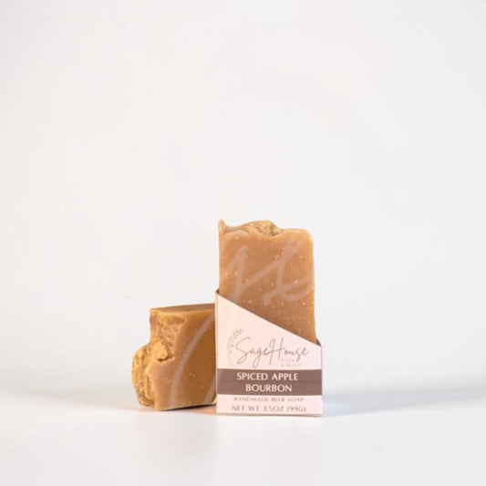 A labeled bar of soap sitting in front of a matching bar. On a white background.