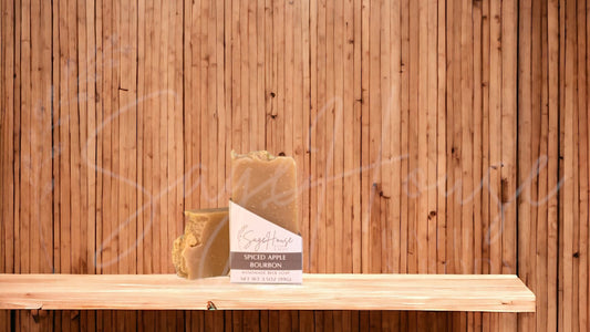 A tan colored bar of soap with a white label. on a wood surface.