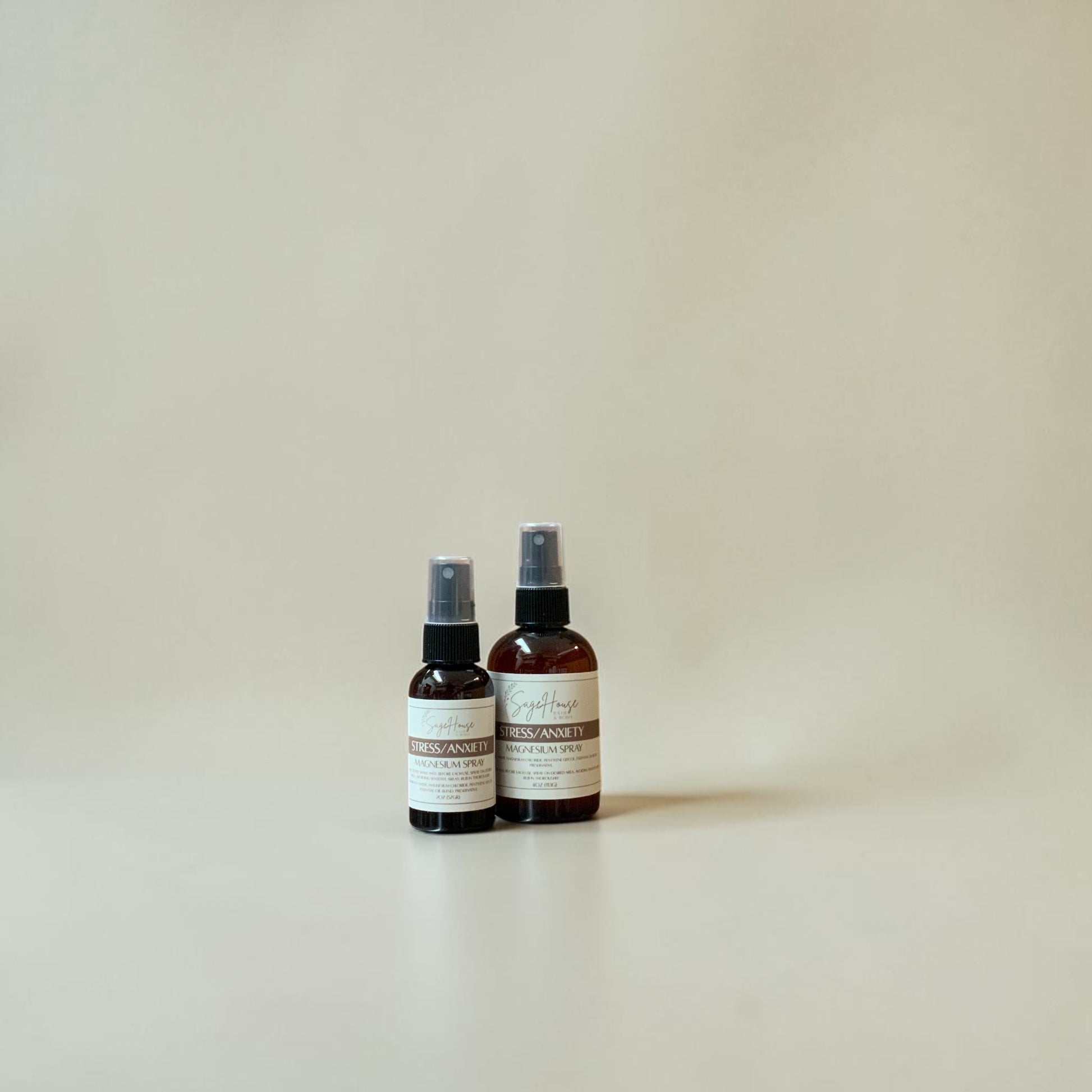 Two spray bottles with labels on a beige background