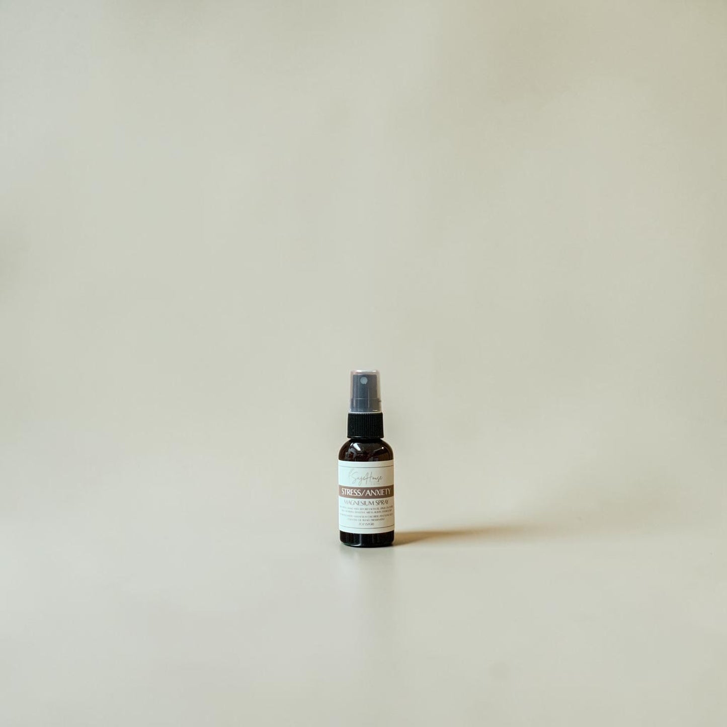 Small spray bottle on a beige background