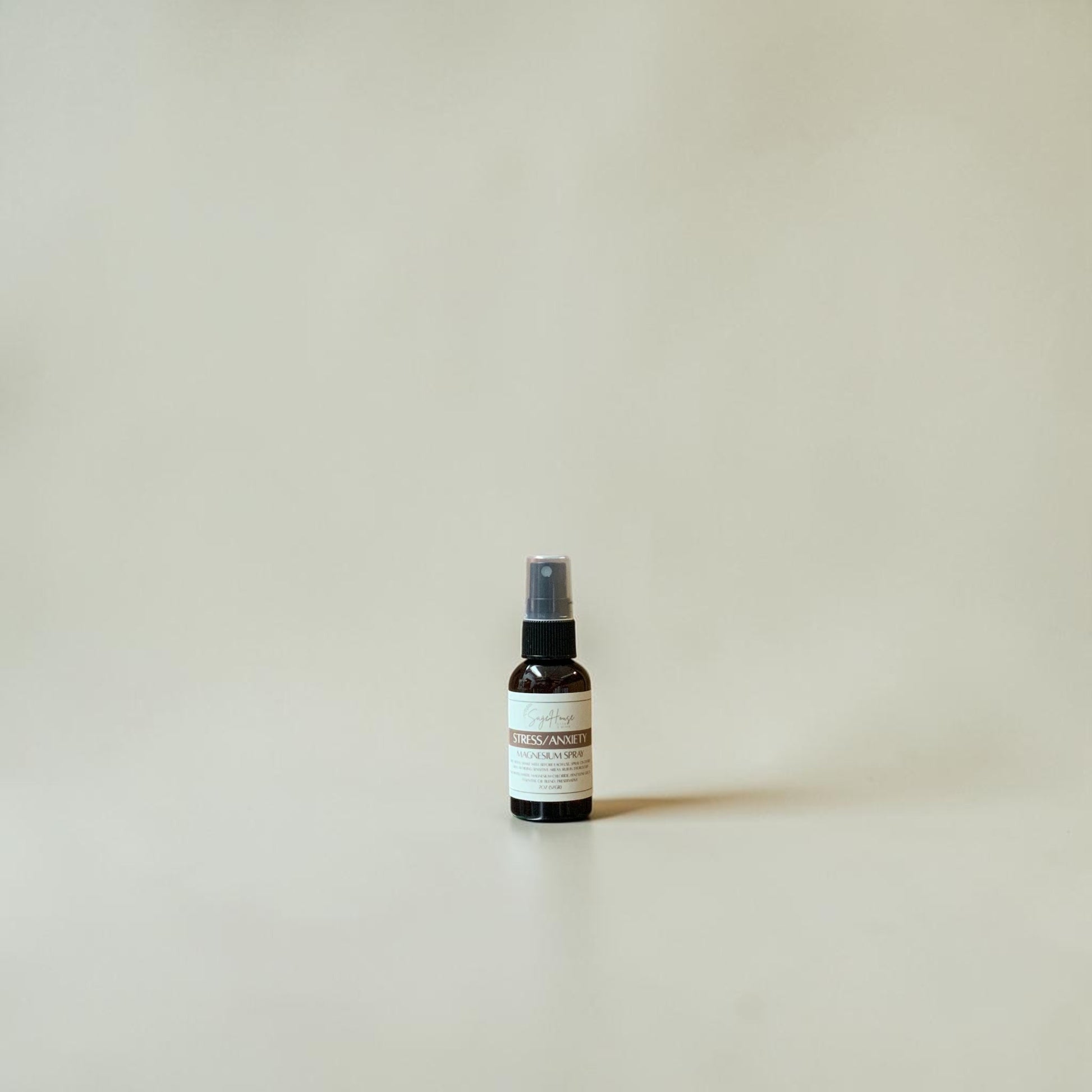 Small spray bottle on a beige background