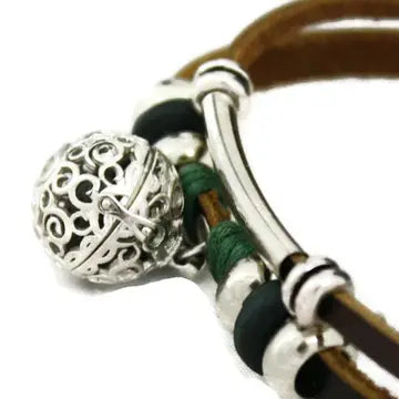 bracelet with brown leather and silver and black beaded accents. lava bead inside of silver ball