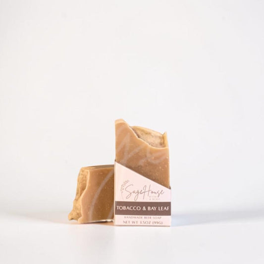 A labeled bar of soap sitting in front of a matching bar. On a white background.