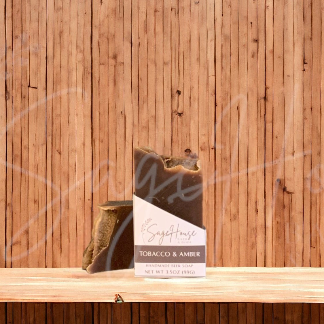 A dark brown colored bar of soap with a white label. on a wood surface.