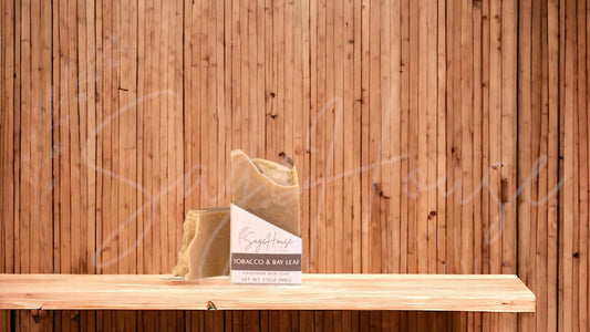A tan colored bar of soap with a white label. on a wood surface.
