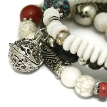 bracelet with white, red, black and silver beads. lava bead inside