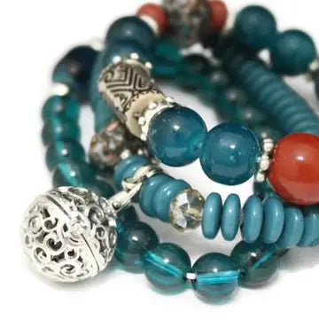bracelet with turquoise, red and silver beads. lava bead inside