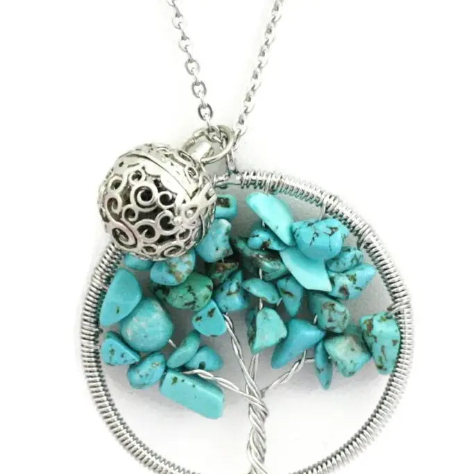 A turquoise stone chakra tree necklace with lava bead inside. on a silver chain