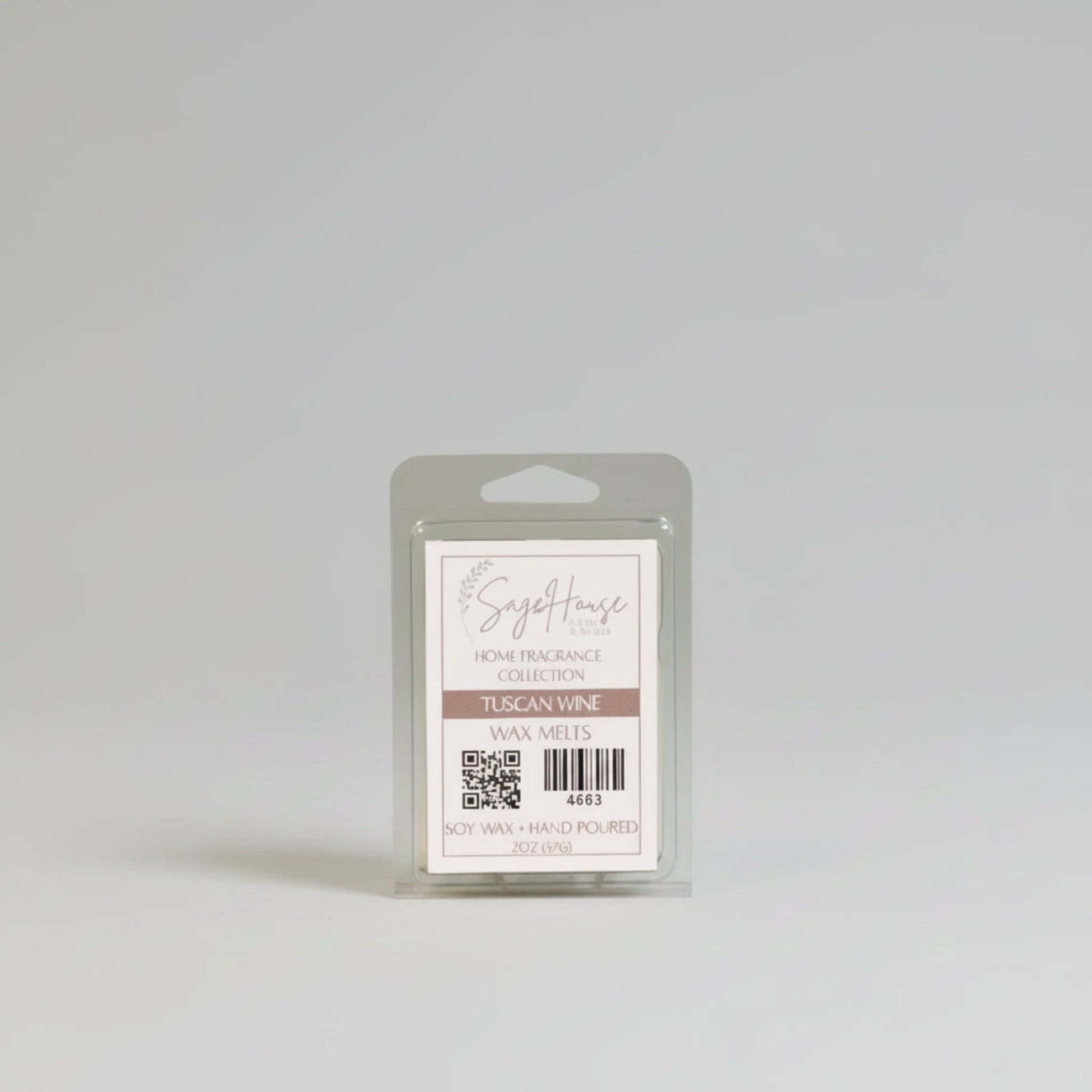 A wax melt clam shell with a white label. Sitting on a wood surface.