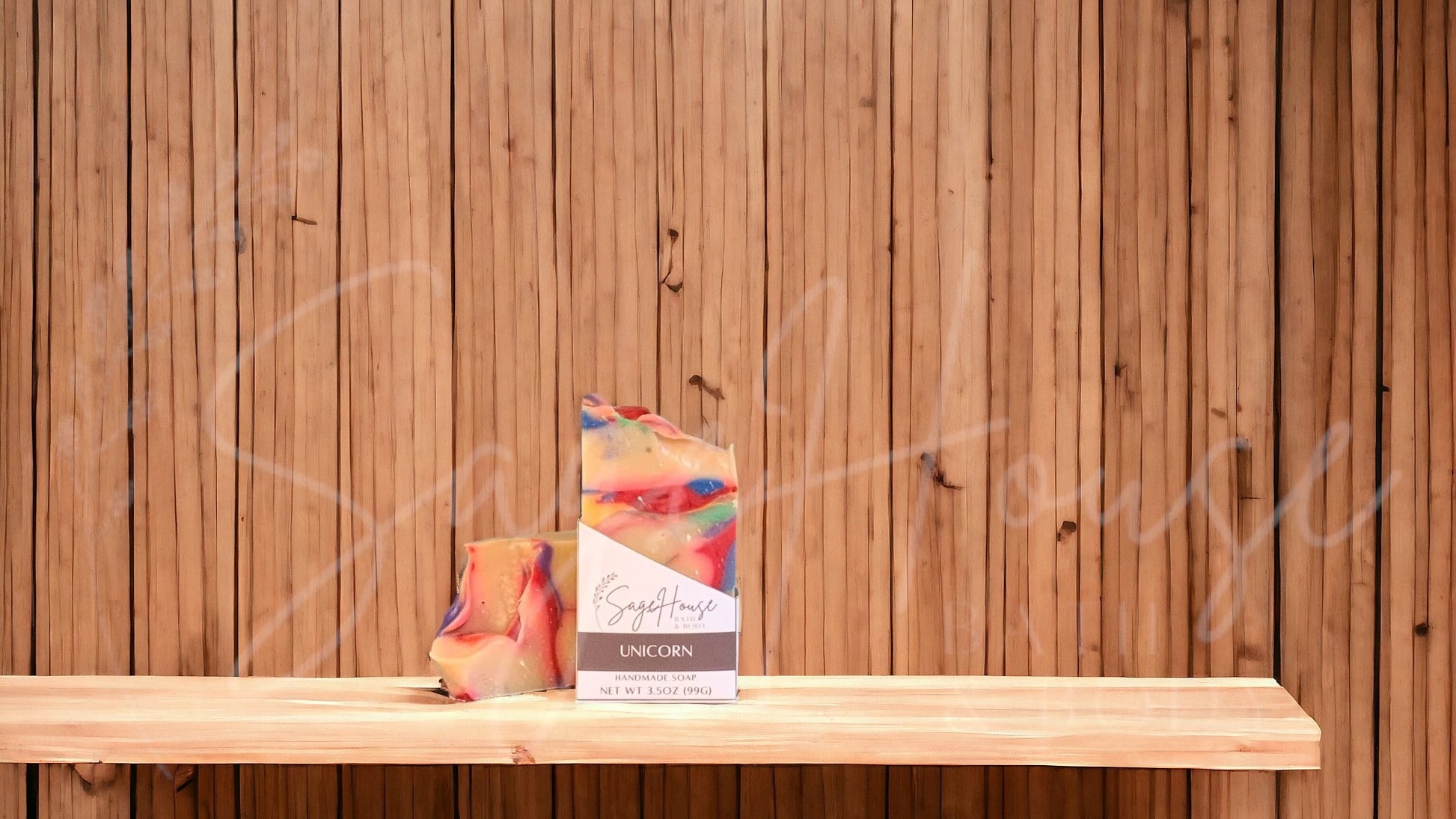 A white bar of soap with rainbow accents of red, blue, yellow, orange, green and purple in a white labeled box, on a wood surface.