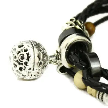 black braided bracelet with wooden beads in neutral colors and silver accents
