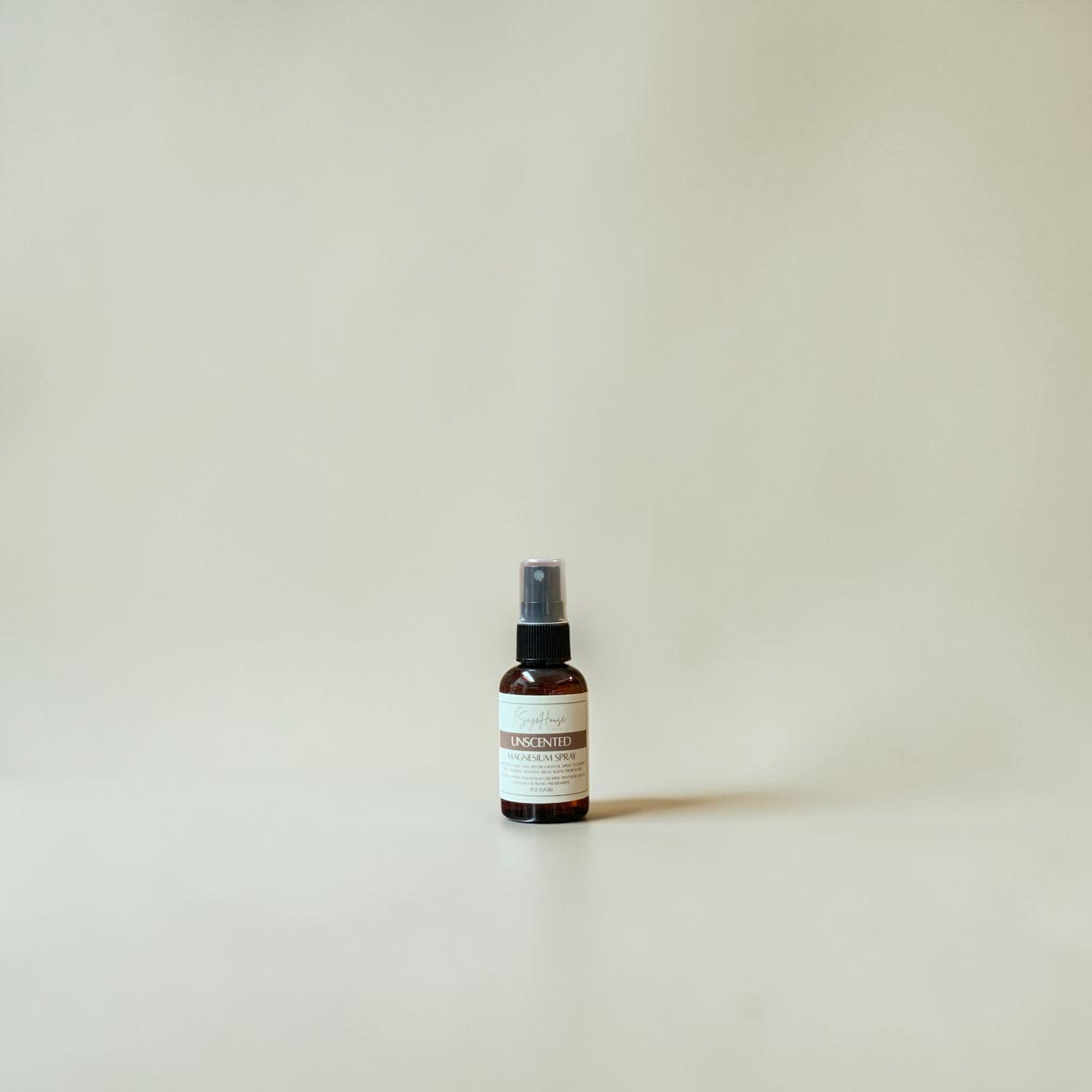 Small spray bottle on a plain background
