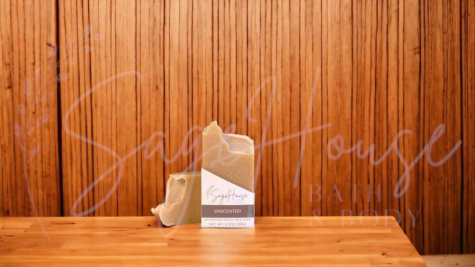 A tan bar of soap in a white labeled box, on a wood surface.