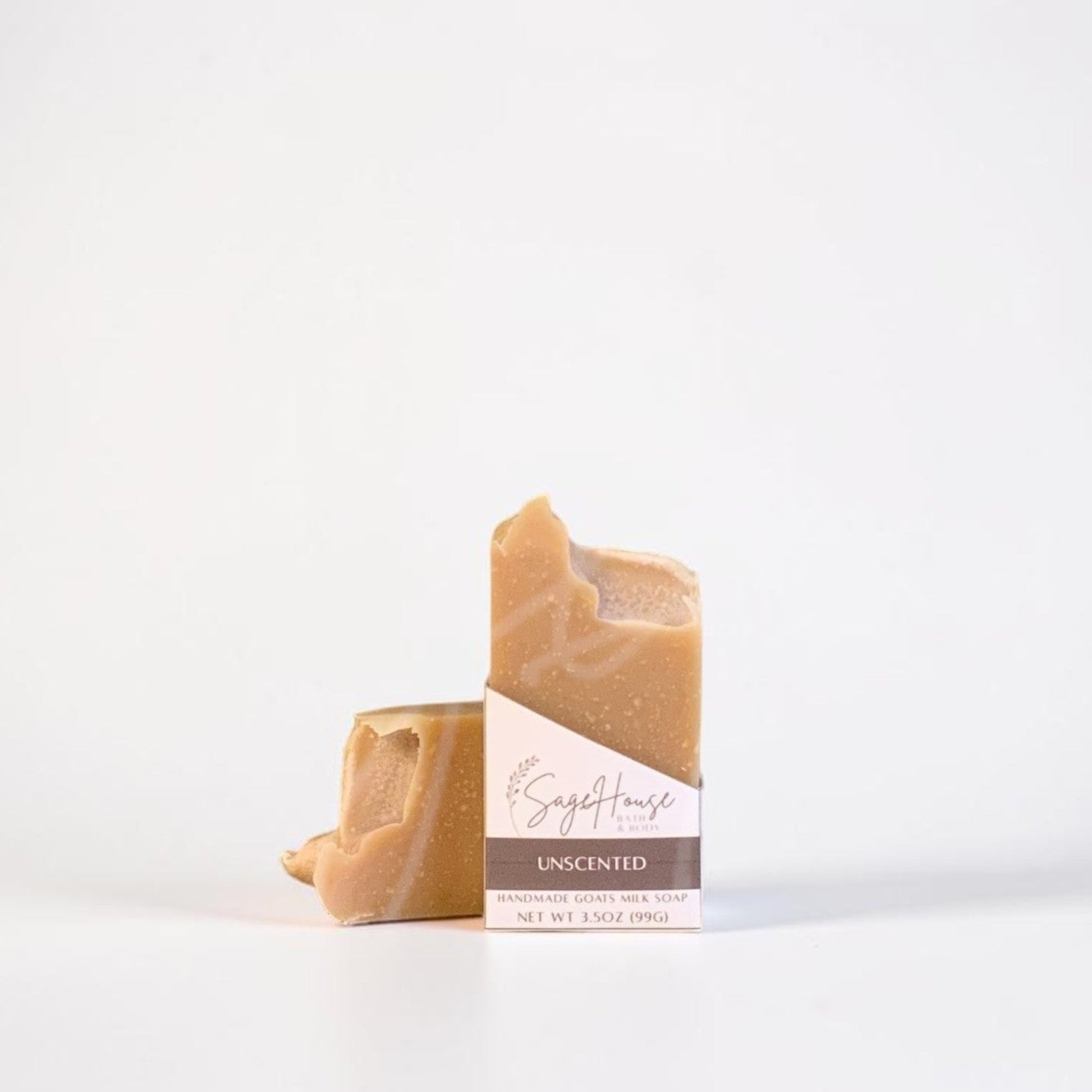 A labeled bar of soap sitting in front of a matching bar of soap. On a white background.