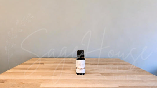 A small bottle of vanilla booster is placed on a wooden surface with a plain background.