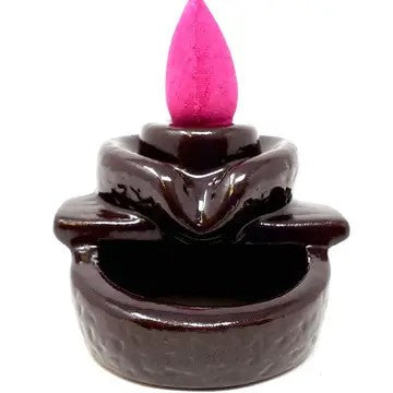 Small black cone incense burner with spout. Cone on top