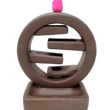 Cone incense burner that is round with stacked shelves inside. Incense cone placed on top.