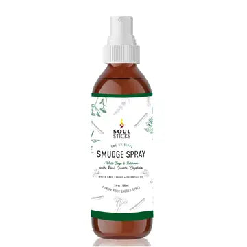 Bottle of white sage & patchouli smudge spray with a white cap on a white background