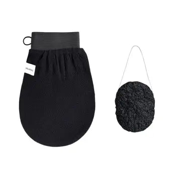 A black exfoliating glove and a bamboo charcoal konjac sponge, likely used for skin care.