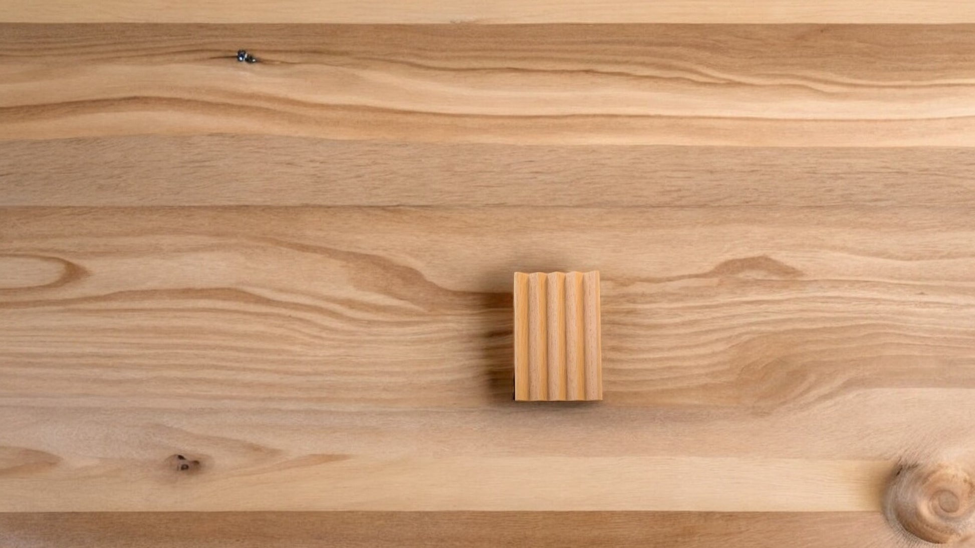 A wooden soap dish with a natural wood background
