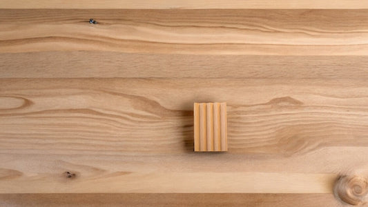 A wooden soap dish with a natural wood background