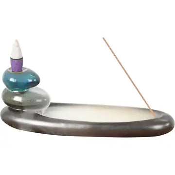 A cone incense burner shaped like long oval stones, with a waterfall of smoke going down each stone into the bottom. On a white background.